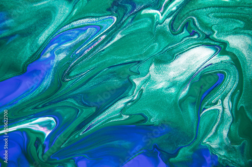 Acrylic paint liquid in trend mint, AquaMenthe and blue color mix background.