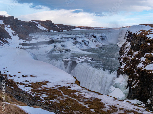 Fantastic waterfall in Iceland, winter tourism,