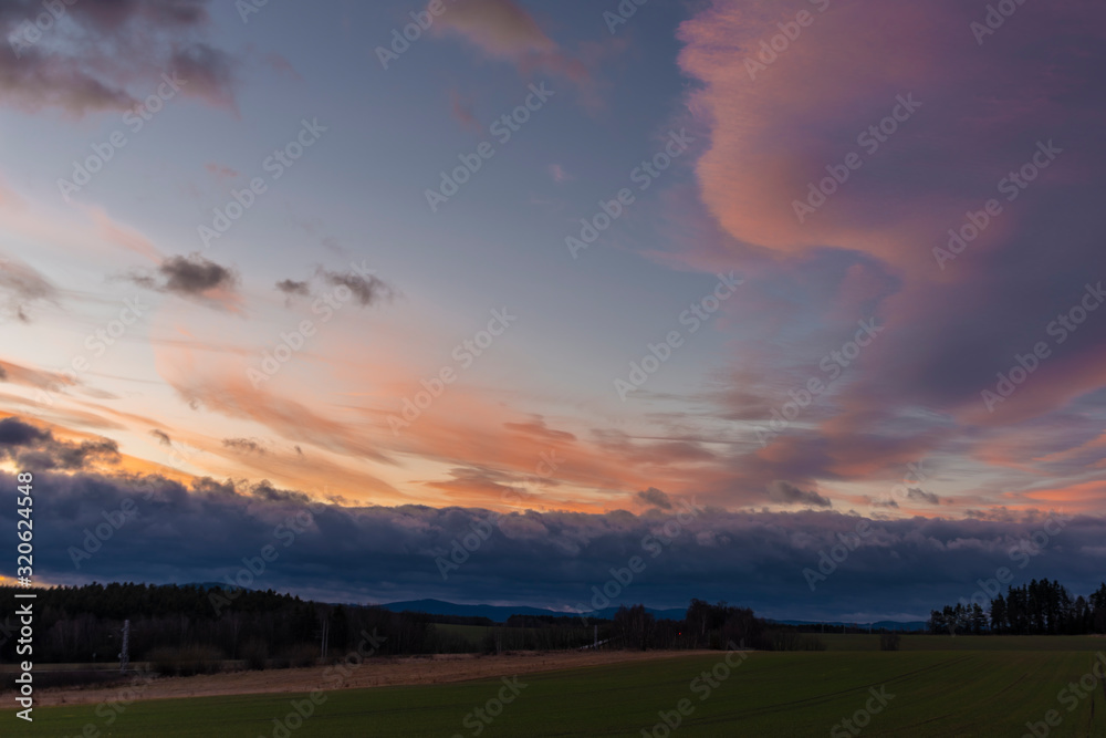 Color sunrise on green field near Vyhen village in south Bohemia