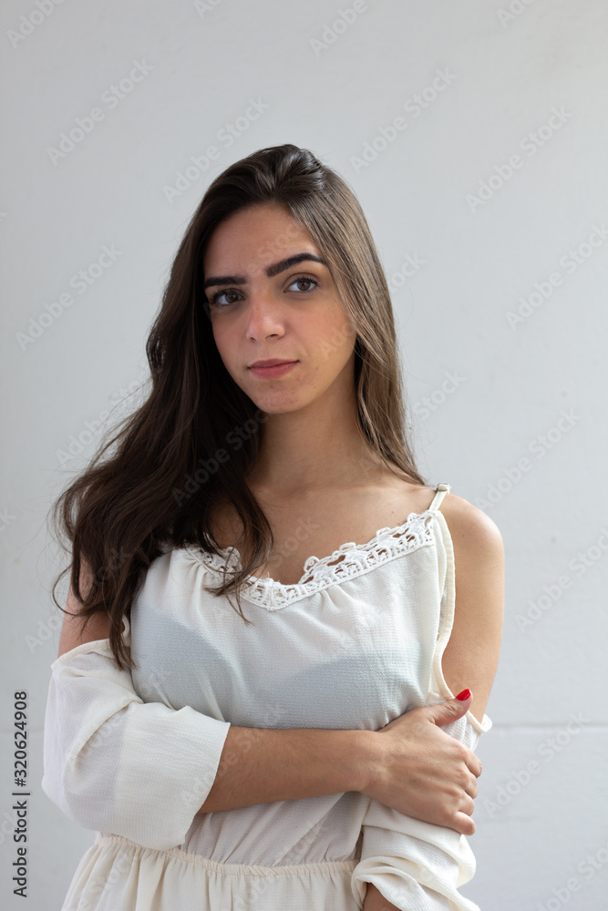 Portrait of young brazilian woman on white background looking at camera. Portrait of young brazilian woman on white background looking at camera.
