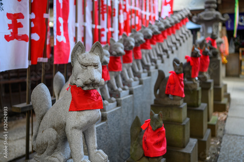 Kitsune fox guardian statues at Toyokama Inari Tokyo Betsuin , Japan photo