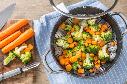 Steamed mixed vegetable in black pot. Healthy vegetable concept