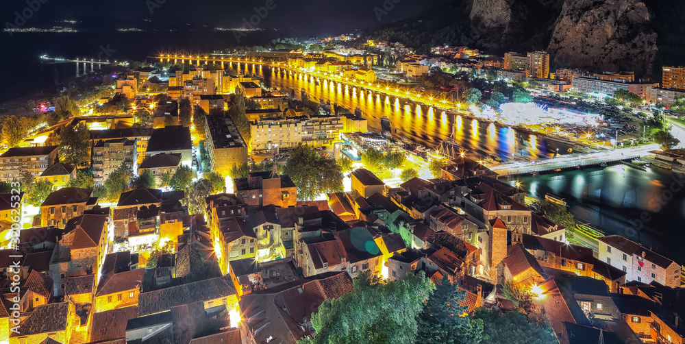 Fototapeta premium Wonderfull aerial panoramic view of Old Town Omis , Cetina river and mountains at night