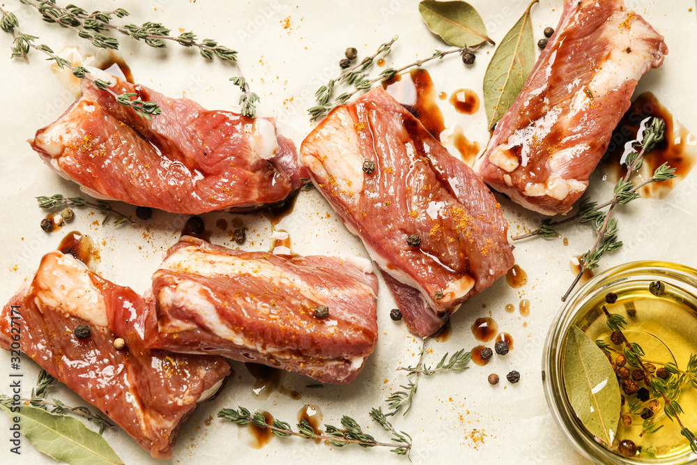 Raw marinated ribs with thyme and peppercorn, flat lay Raw marinated ribs with thyme and peppercorn, flat lay