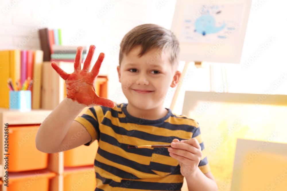 Cute little child with painted palm in room Cute little child with painted palm in room