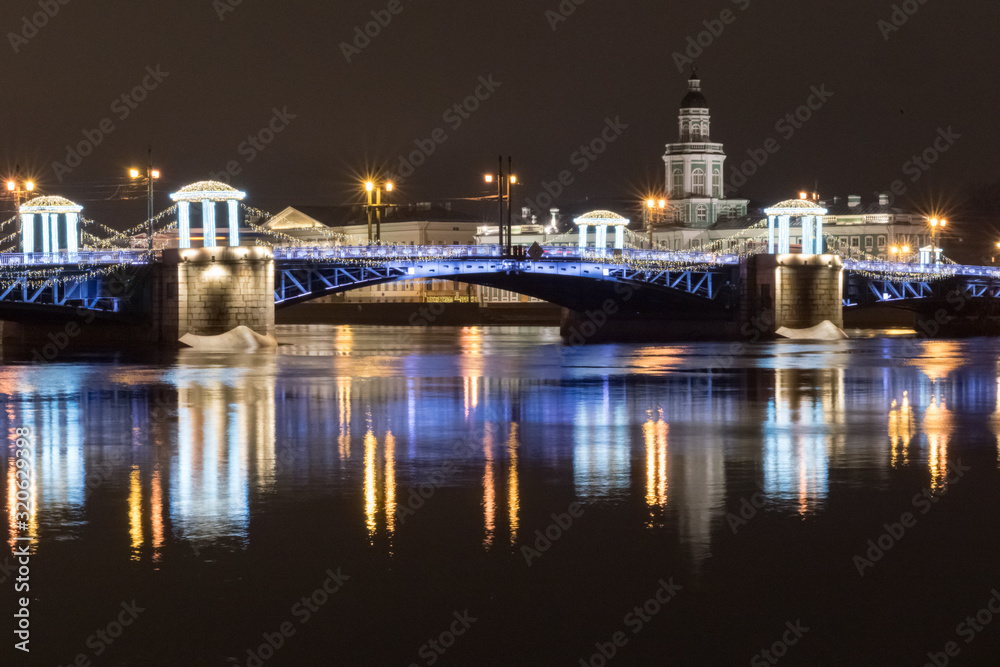 Night view of the Palace Bridge decorated with festive lights for the New Year. Sankt-Peterburg, Russia.