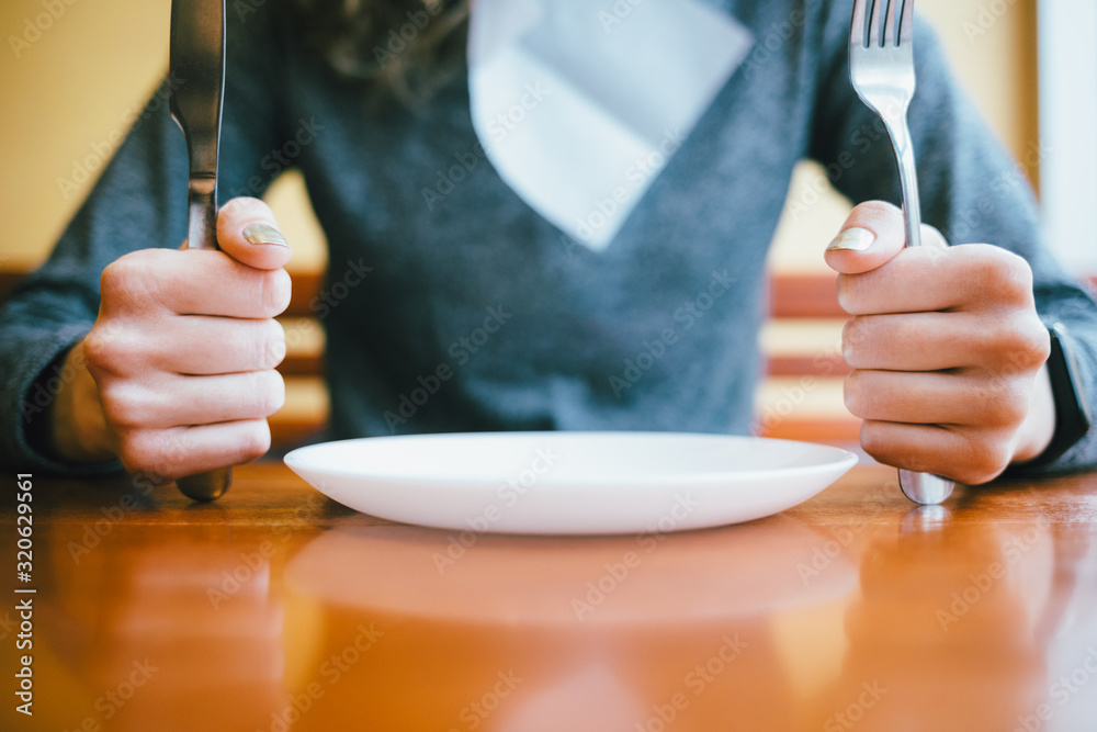 Young woman sitting at table in restaurant Young woman sitting at table in restaurant