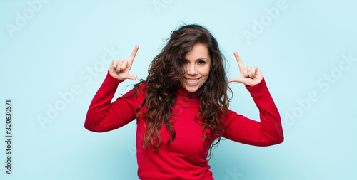 Schilderij op canvas young pretty woman framing or outlining own smile with both hands, looking posit