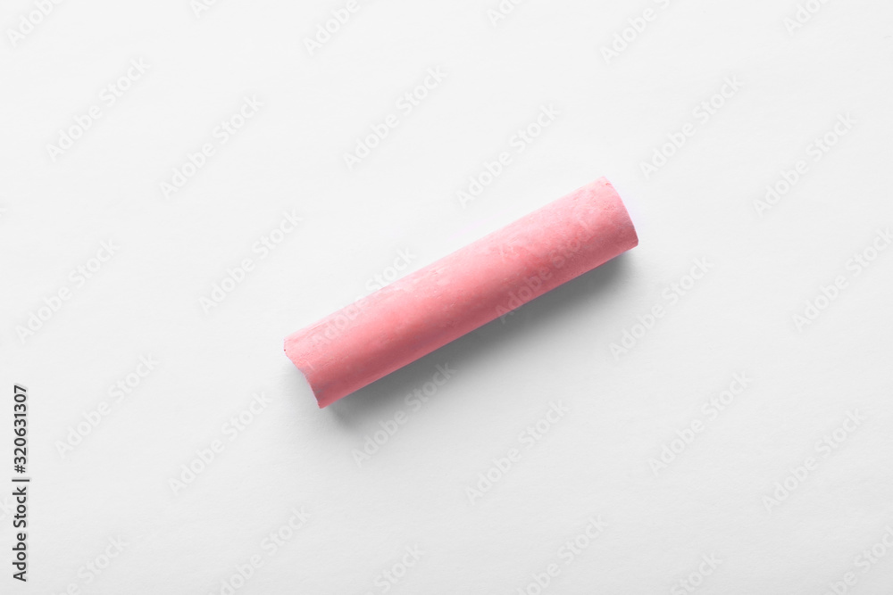 Fototapeta premium Small piece of pink chalk isolated on white, top view
