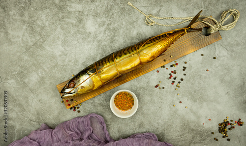 Appetizing smoked fish on kitchen board.Smoked fish with spices