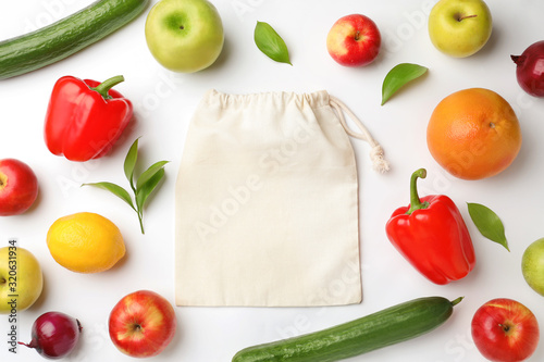 Fototapeta Naklejka Na Ścianę i Meble -  Cotton eco bag, fruits and vegetables on white background, top view