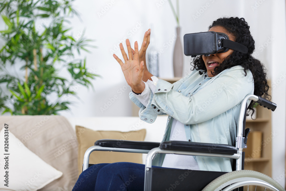 woman in a wheelchair using virtual reality masks