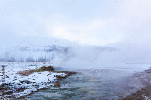 Incredible winter landscape of Iceland. In winter, a source of hot water flows in the mountains