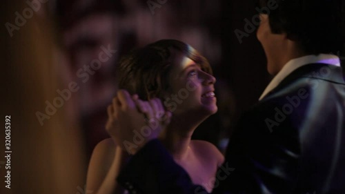 A teenage boy and girl dancing at a senior prom high school dance