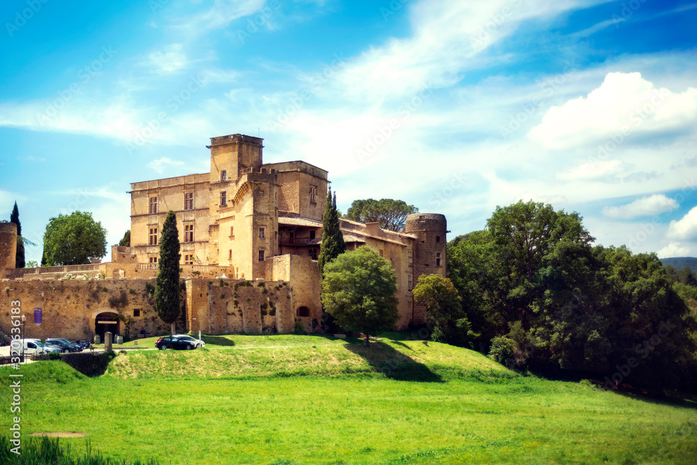 Medieval ancient old traditional famous castle Lourmarin chateau in sunny day in Luberon, Provence, France - famous tourist attraction, vacation destination, tourism.