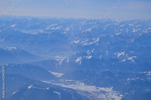 snow-covered German Alps photographed from a plane window