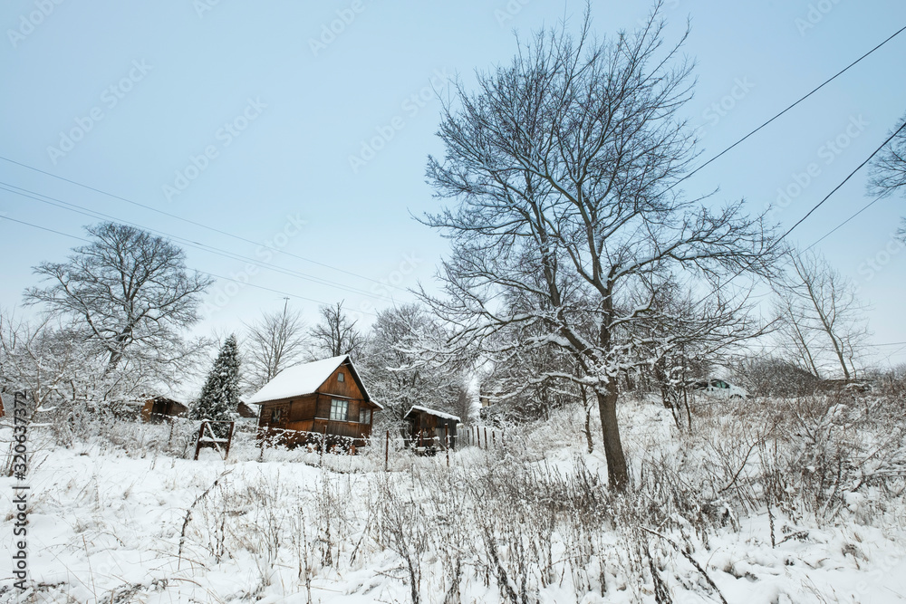 Blue sky with snow field and house. Great background with copyspace. Winter and snow landscape. Stock photo.