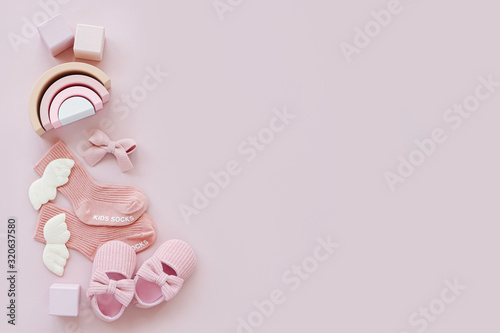 Pink socks, shoes and toys. Set of baby stuff and accessories for girl on pastel background. Baby shower concept.  Fashion newborn. Flat lay, top view
