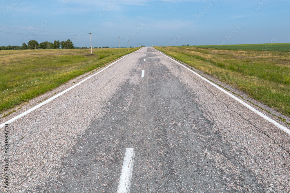 asphalt road goes far into the horizon