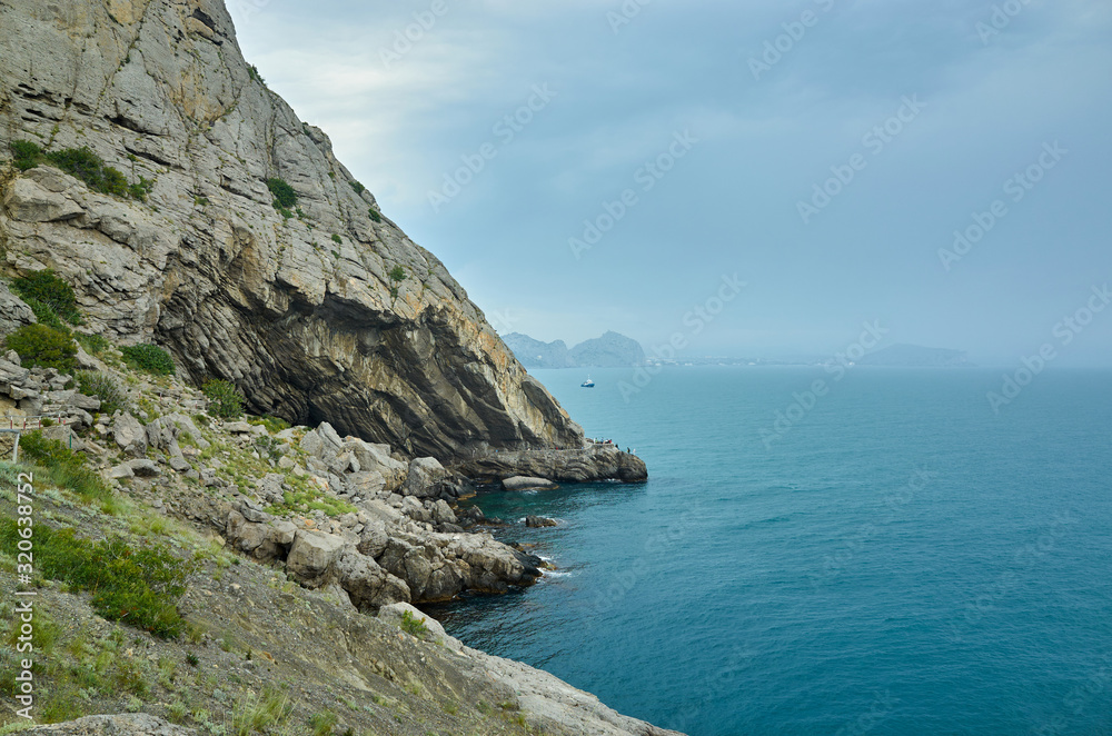 A tourist route along a trail in the mountains of the southern coast of Crimea, a beautiful view of the Black Sea and rocks. Golitsyna trail, Republic of Crimea