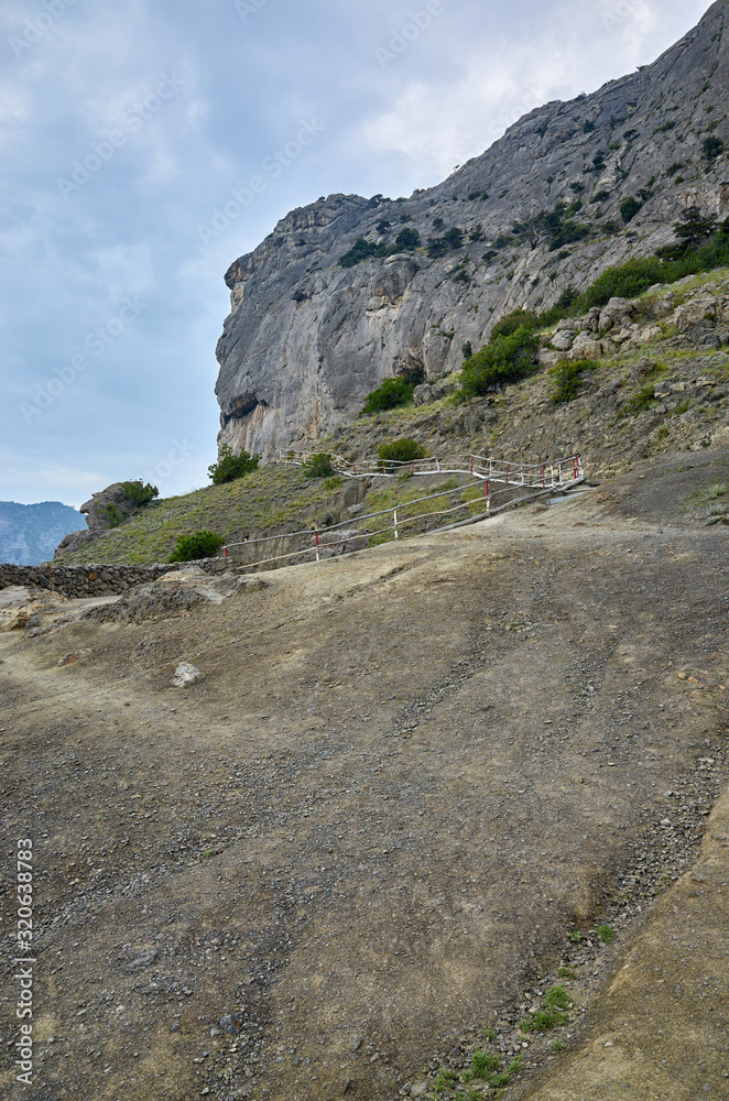 A tourist route along a trail in the mountains of the southern coast of Crimea, a beautiful view of the Black Sea and rocks. Golitsyna trail, Republic of Crimea