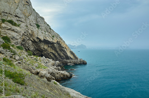 Obraz na płótnie A tourist route along a trail in the mountains of the southern coast of Crimea, a beautiful view of the Black Sea and rocks. Golitsyna trail, Republic of Crimea w salonie