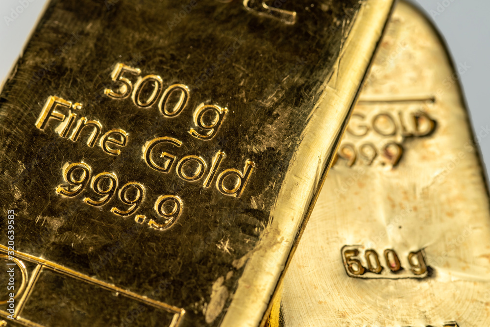 The surface of two cast gold bar weighing 500 grams each. Selective focus. The surface of two cast gold bar weighing 500 grams each. Selective focus.