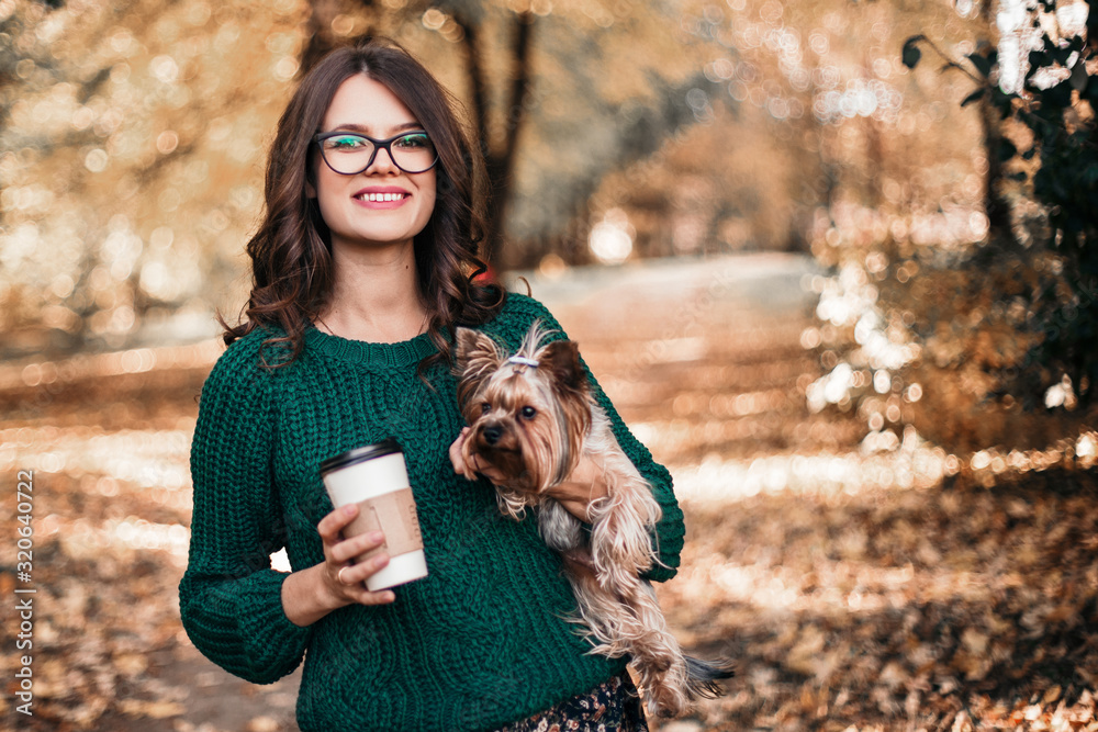 Beautiful woman walk with dog and drink coffee in the park. Beautiful woman walk with dog and drink coffee in the park.