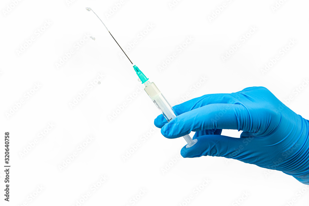 Medical syringe and antibiotic ampoule on a white background in hand Medical syringe and antibiotic ampoule on a white background in hand