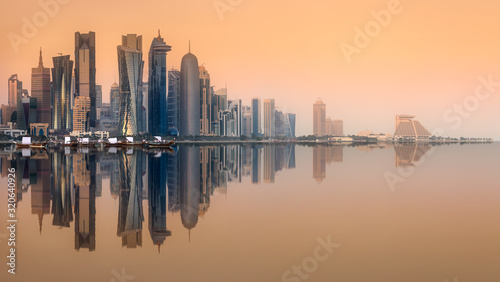 Skyline of West Bay and Doha City with reflection of buildings on water, Qatar