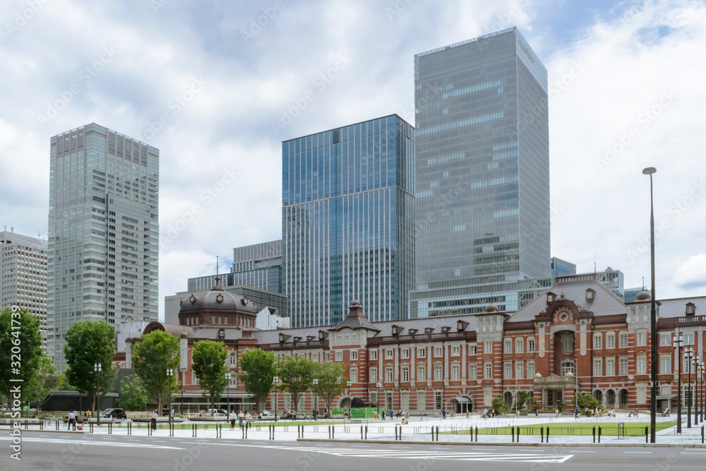 Urban background with Tokyo downtown Marunouchi business district with detail of vintage Tokyo railway station building integrated in modern architecture.