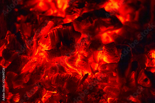 Glowing Hot Charcoal Briquettes Close-up Background Texture