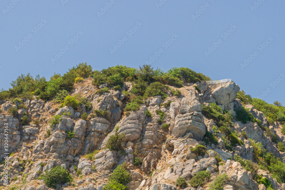 Mountains and rocks on the beach in summer on a Sunny day