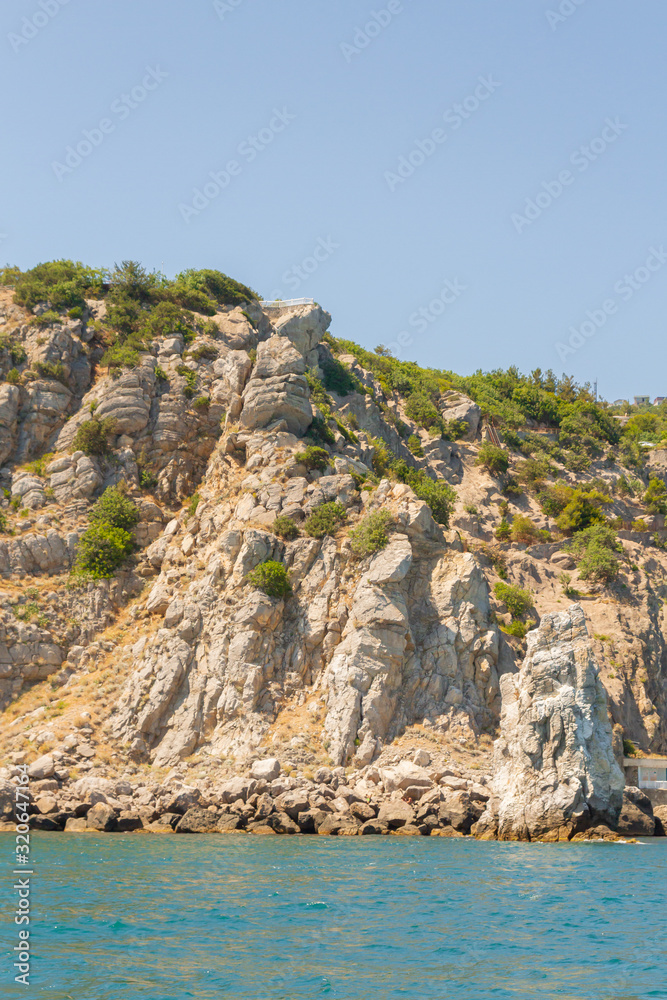 Mountains and rocks on the beach in summer on a Sunny day Mountains and rocks on the beach in summer on a Sunny day