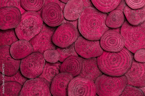 Background of heap fresh colorful beetroot slices photo