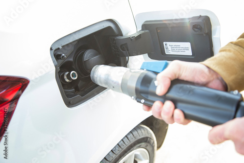 Man filling his car's tank with compressed natural gas.