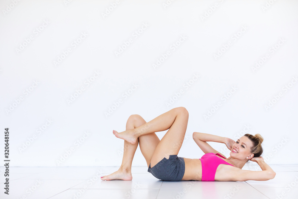 Fitness woman doing exercises on the press indoors. Fitness woman doing exercises on the press indoors.