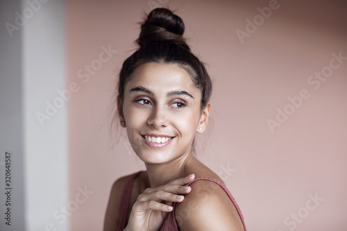 Portrait close-up of beautiful young woman  with perfect skin and toothy smile.