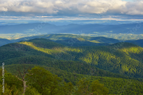 Early morning light illuminates portions of the Blue Ridge and Allegheny mountains near Lexington, Virginia.  Photographed along the Blue Ridge Parkway. photo