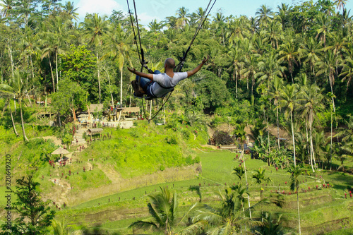 Happiness and freedom. Tegalalang rice terrace swing, Bali, Indonesia