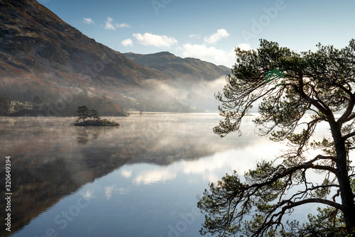 Dawn light and transient sunlit mist over Wall Holm Island on Ullswater, Lake District National Park, Cumbria photo