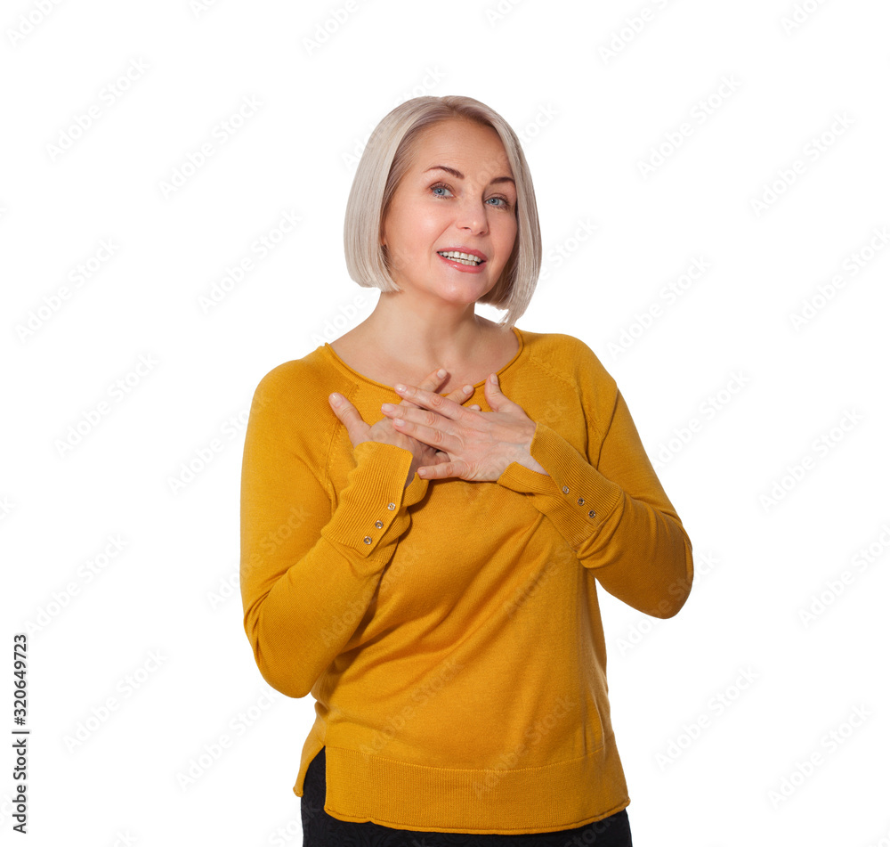 Middle aged blonde emotionally posing in a studio. Happy woman in yellow bright sweater on white background Middle aged blonde emotionally posing in a studio. Happy woman in yellow bright sweater on white background