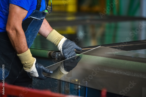 worker is cutting glass panes