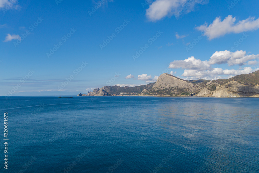 Beautiful view to coast of Novy Svet village from rocky coast Alchak Cape in surroundings of resort Sudak city, Crimean peninsula.