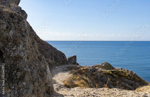 Scenic landscape with rocky coast of the Black Sea in surroundings of Sudak, Crimean peninsula. Cape Alchak in Sudak, Crimea