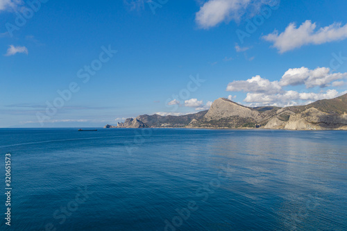 Beautiful view to coast of Novy Svet village from rocky coast Alchak Cape in surroundings of resort Sudak city, Crimean peninsula.