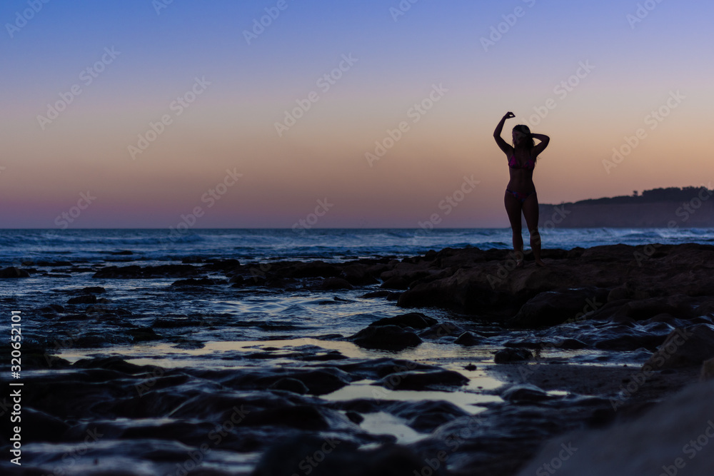 silhouette of a woman on the beach