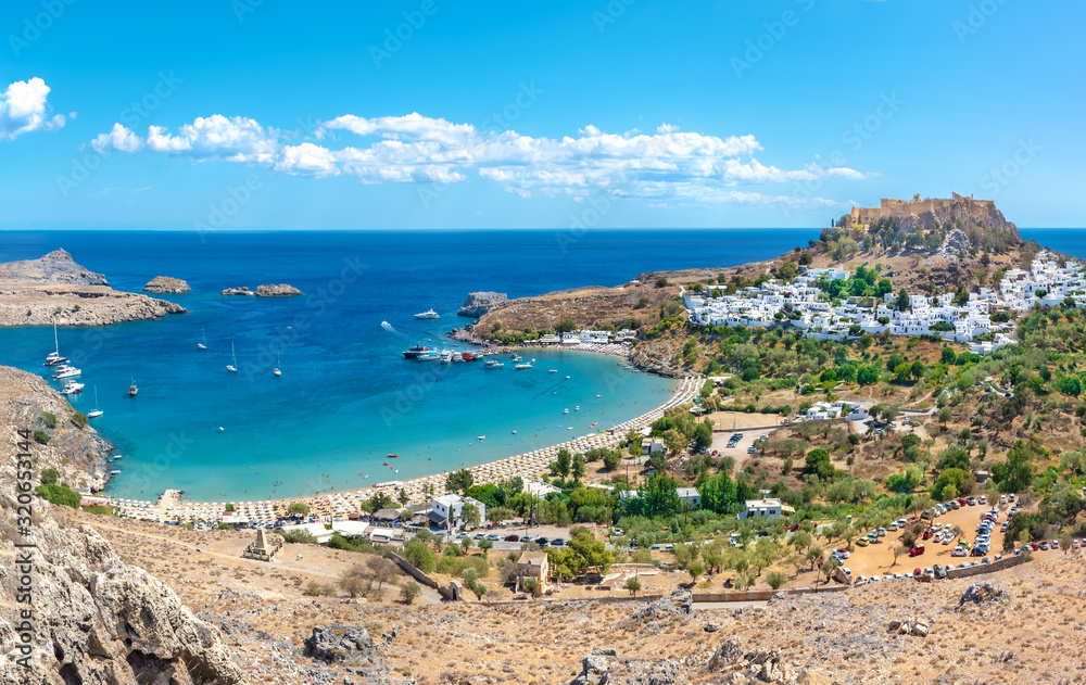 View of Lindos beach with village of Lindos and Acropolis in background (Rhodes, Greece)