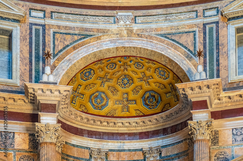 Rome, Italy - Interior of Roman Pantheon ancient temple, presently catholic Basilica, with its reach decorations, arches and colonnades covered with golden and colorful paintings