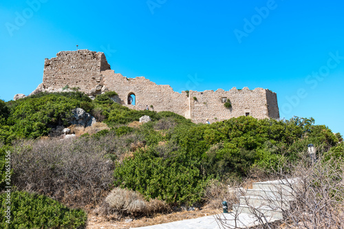 Stairs through bushes to ruins of medieval castle Kritinia  Rhodes  Greece 